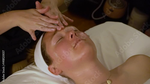 Woman getting facial at spa