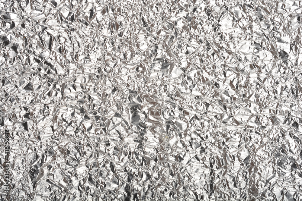 A top-down close-up shows a heavily crumpled and textured sheet of shiny aluminum foil