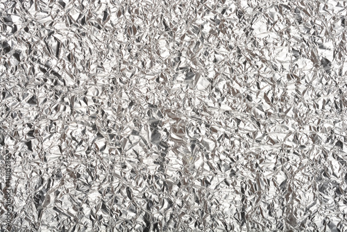 Obraz na płótnie A top-down close-up shows a heavily crumpled and textured sheet of shiny aluminum foil w salonie