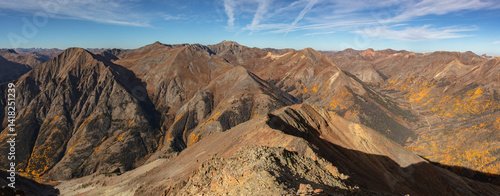 The amazing colors of the San Juan Range mountains west of Lake City Colorado accented by colorful autumn aspen trees. Captured from 13er Sundog peak