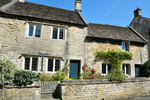 Old stone cottage houses on a street in an English town