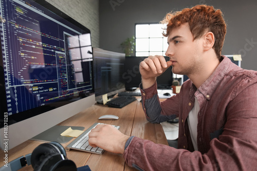 Male programmer working wit...