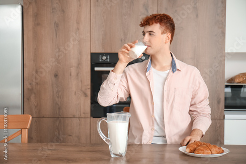 Young redhead man drinking ...