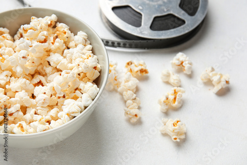 Bowl with tasty popcorn and...