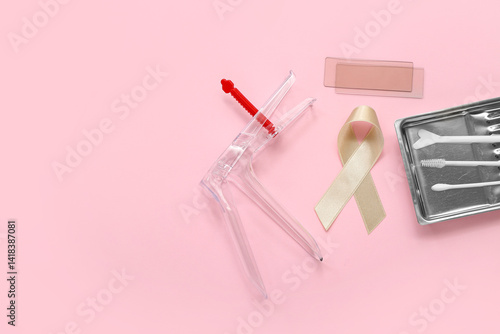 Beige ribbon with gynecological tools on pink background. Uterine cancer awareness concept