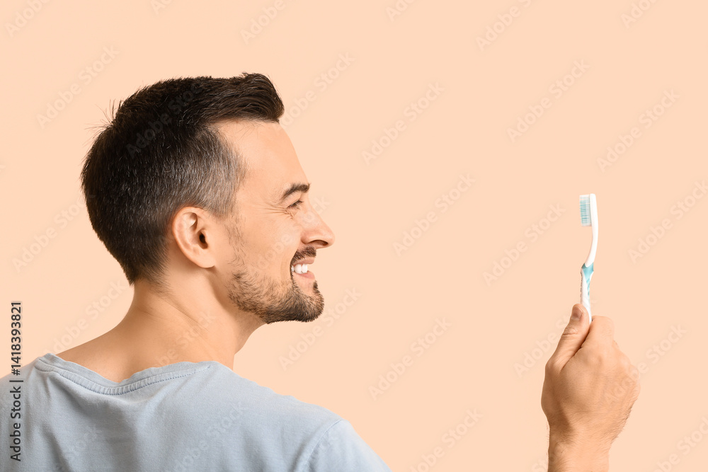 Handsome man with toothbrush on beige background, back view Handsome man with toothbrush on beige background, back view
