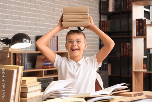 Teenage boy with books at t...
