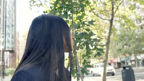 Native American woman with Hispanic features and Chilean descent, sitting during her coffee break, holding a mug and phone, looking thoughtful and determined, with a corporate city skyline in the back