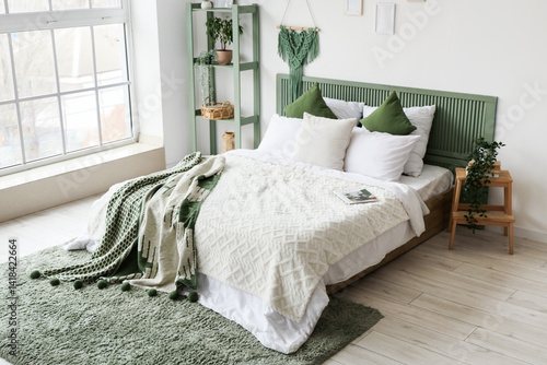 Obraz na płótnie Modern bed with green plaid and shelving unit in interior of bedroom w salonie