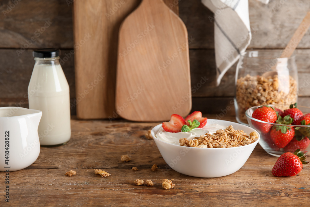 Bowl with tasty granola, yogurt and berries on wooden background