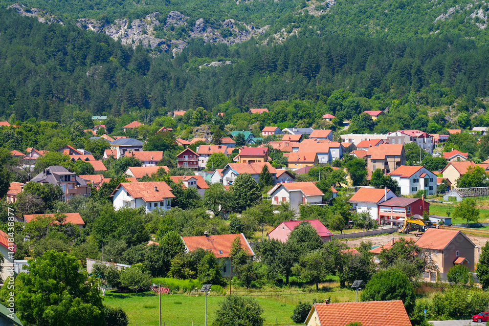 Aerial view of Cetinje, the former capital of Montenegro in the Balkans - Houses in a lush valley surrounded by the mountains of Eastern Europe