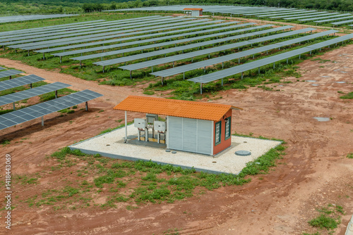 aerial images of photovoltaic sites for Solar Energy: panel modules and electrical rooms with inverters for clean energy generation