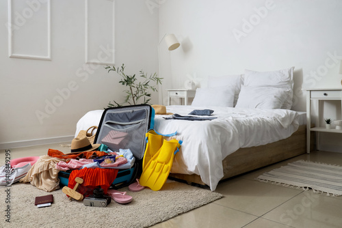 Open suitcase with clothes ...
