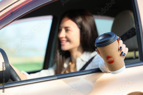 Happy young woman with coff...