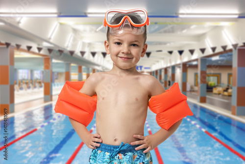 Obraz na płótnie Cute little boy in trunks with diving mask and swim armbands at indoor swimming pool w salonie