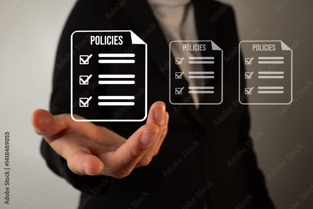 A woman is holding a hand up to a screen with a policy check list A woman is holding a hand up to a screen with a policy check list