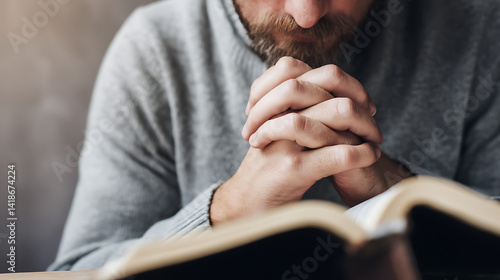 Close up of a man reading the Holy Bible and praying. Concept of religiosity and mystery