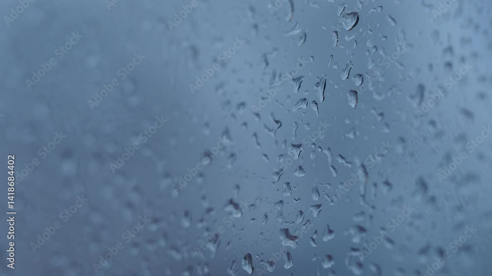 Raindrops accumulate on a window during a quiet afternoon Raindrops accumulate on a window during a quiet afternoon
