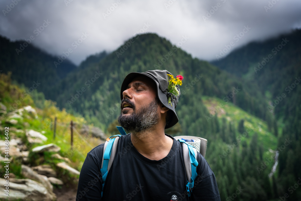 Naklejka premium Portrait of a hiker wearing a hat decorated with wildflowers, resting on a mountain trail in the Himalayas