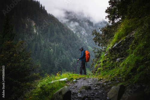 фотографія A trekker with hiking backpack on beautiful mountain landscape background