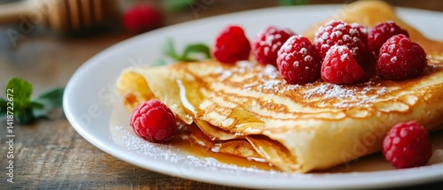 a close-up of french crepes with raspberry and honey topping