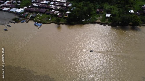 Aerial Majesty of Quibdó: River, Faith, and Rainforest. Drone views of Quibdó, Choco, Colombia, featuring the Atrato River, boats, rainforest, and the iconic cathedral. A vibrant mix of nature.