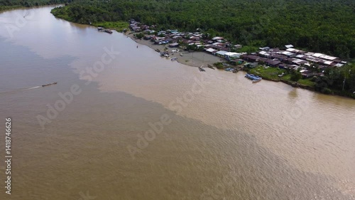 Aerial Majesty of Quibdó: River, Faith, and Rainforest. Drone views of Quibdó, Choco, Colombia, featuring the Atrato River, boats, rainforest, and the iconic cathedral. A vibrant mix of nature.