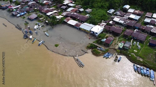 Aerial Majesty of Quibdó: River, Faith, and Rainforest. Drone views of Quibdó, Choco, Colombia, featuring the Atrato River, boats, rainforest, and the iconic cathedral. A vibrant mix of nature.