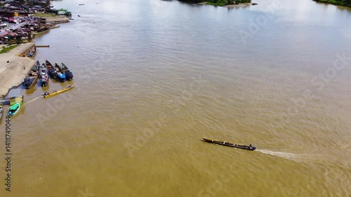 Aerial Majesty of Quibdó: River, Faith, and Rainforest. Drone views of Quibdó, Choco, Colombia, featuring the Atrato River, boats, rainforest, and the iconic cathedral. A vibrant mix of nature.
