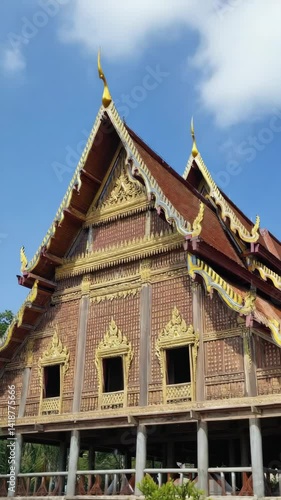 Wallpaper Mural Elaborate architectural details of a temple showcasing wood paneling, roof finials, windows, and elaborate trim against a clear blue sky. Torontodigital.ca