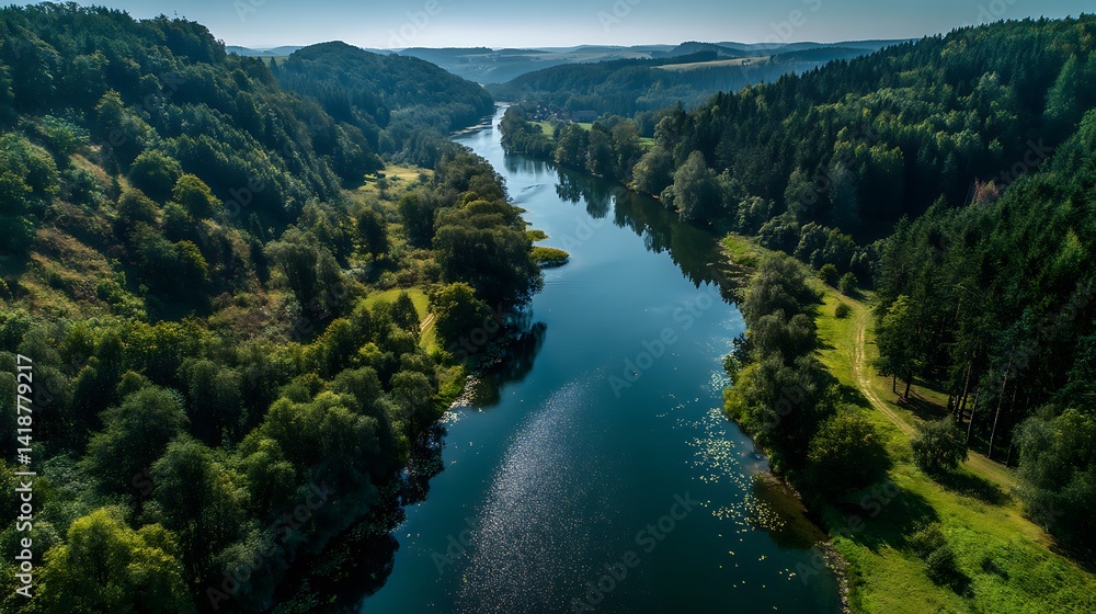 Obraz premium Serene river winding through lush valley. High-angle view of a calm river flowing between forested hills