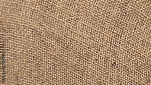 Hessian sackcloth woven fabric texture background in beige cream brown color stock photo.