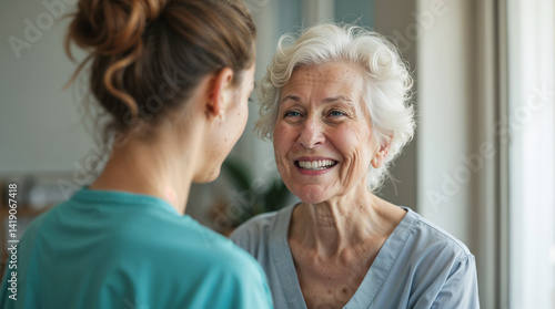 Portrait of happy elderly woman with female caretaker indoors. Care and support of seniors in private clinic hospice nursing house.