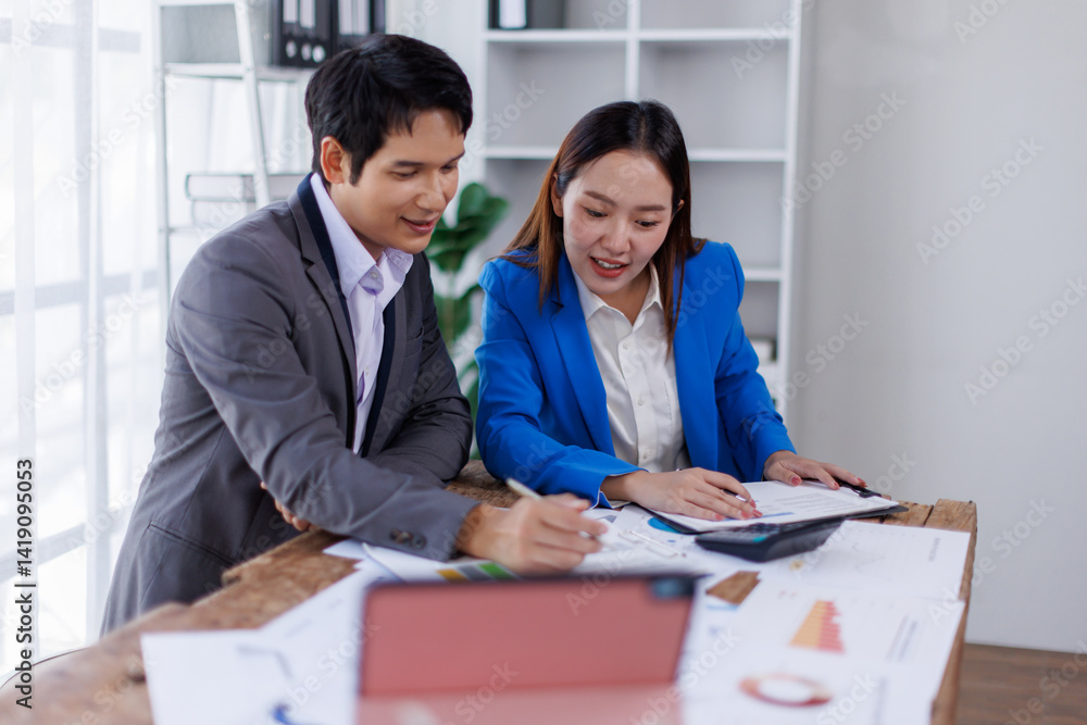 Obraz premium Team of Accounting business are calculating income-expenditure and analyzing real estate investment data on tablet computer, Financial and tax systems concept. 