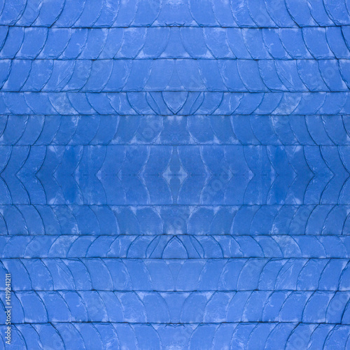 The old blue tile wall. Blue stone background. The texture of the tile. Brickwork. Seamless image. Symmetrical.