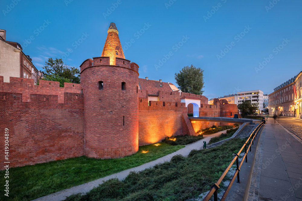 Illuminated historic city walls of Warsaw originally raised between the 13th and 16th centuries, then rebuilt in 1950–1963