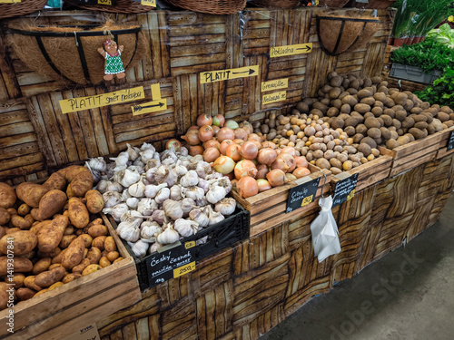 Sticker Fresh potatoes, onions, and garlic on display at a farmers Holesovice market in