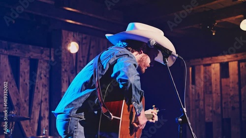 Country Musician Performing Emotionally on Stage with Lighting  