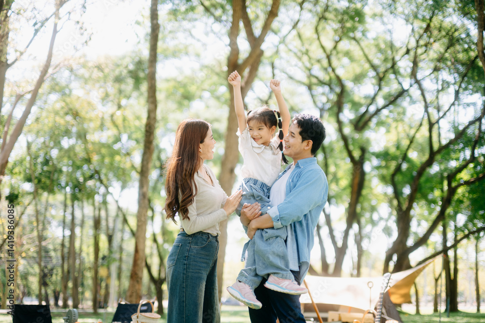Happy parents and daughter Bakery and Bread Fruit enjoy in a sunny garden. A joyful summer picnic full of love, food for family Happy parents and daughter Bakery and Bread Fruit enjoy in a sunny garden. A joyful summer picnic full of love, food for family