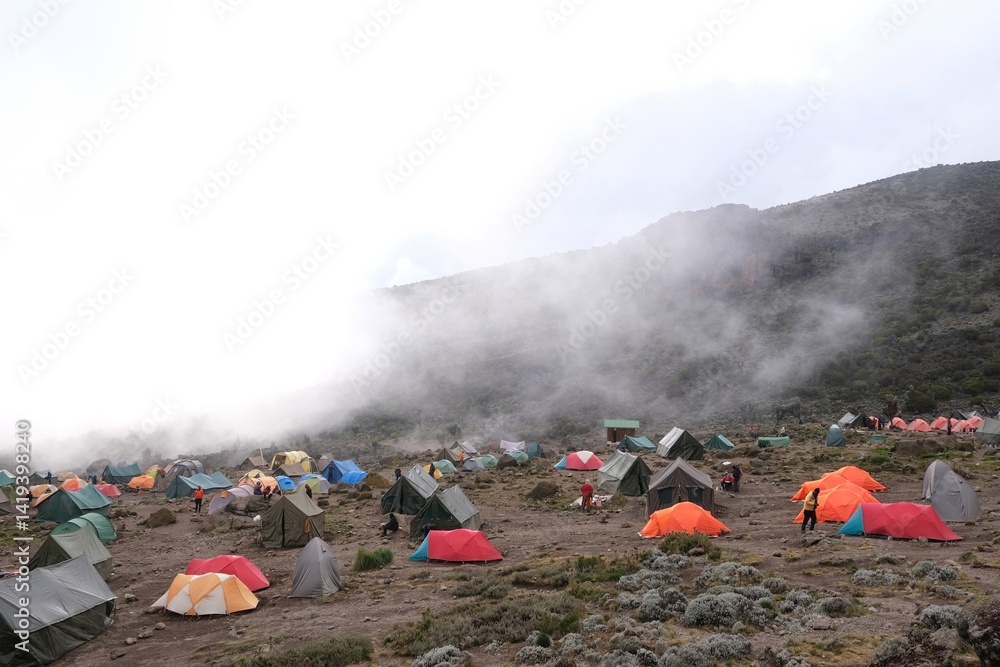 Misty scenery of Barranco Camp with tents on trail to Kilimanjaro Peak, Machame Route, Tanzania