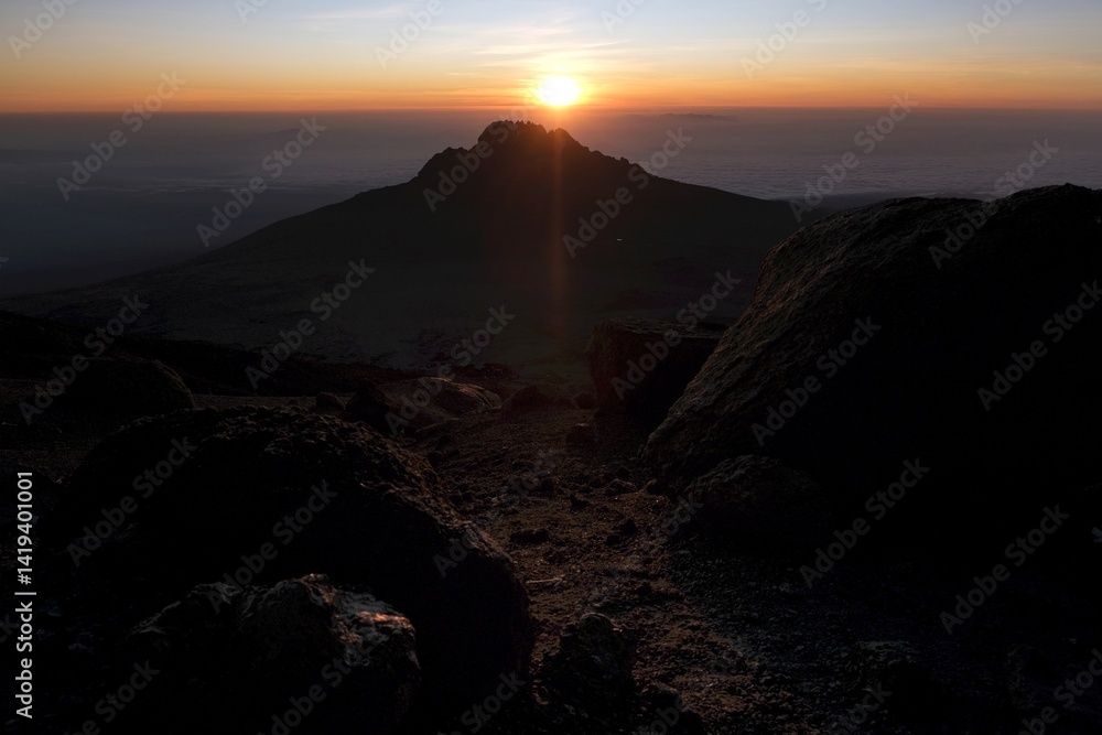 Sunset scenery with Mawenzi Peak on horizon during climbing to Uhuru peak on Kibo volcano (Kilimanjaro) – 5895 m. Tanzania