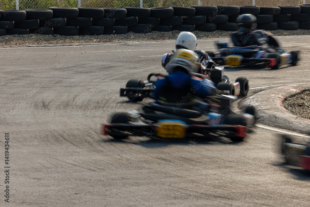 Motion blur kart driver drive go kart on kart race track circuit, Go kart racer driver on curve race track, Extreme sport .