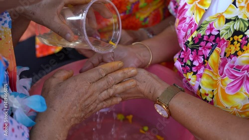 The tradition of pouring water over the head on Songkran Day in Thailand