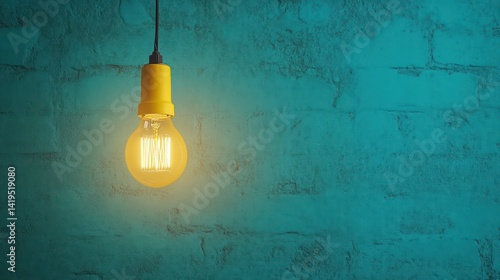 Illuminated bulb against teal brick wall