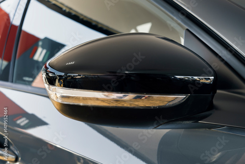 Fotomural Side view mirror of a modern car, with glossy black finish and integrated turn signal