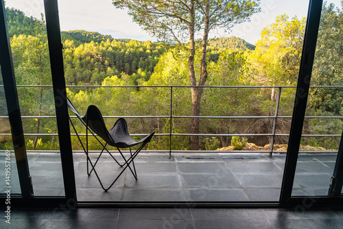Terrace with chair to enjoy the amazing views of the forest at sunrise.
