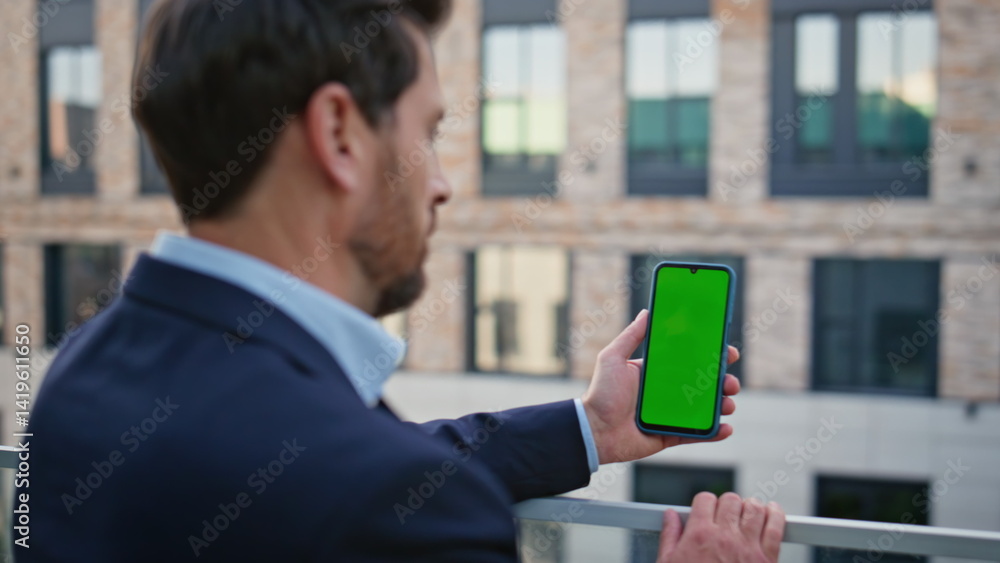 Man watching mockup smartphone screen outdoors closeup. Director holding phone