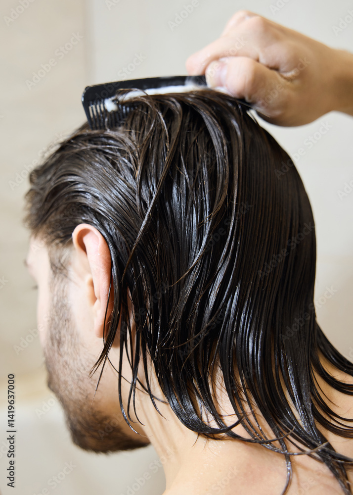 Naklejka premium a brunette with long hair applies hair balm, caring for them