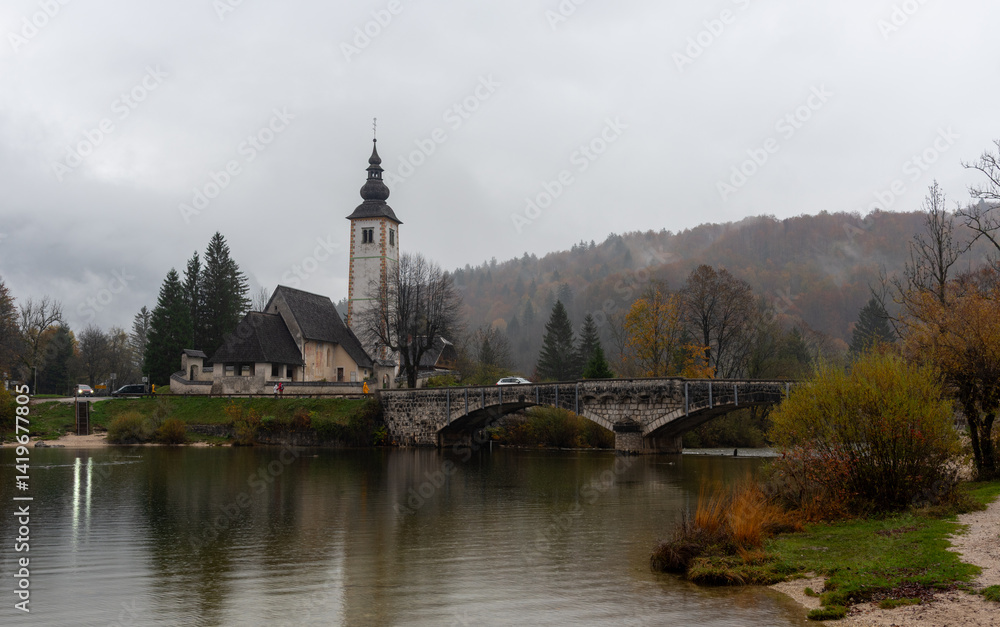 Tranquil scene of st. John the baptist's church by bohinj lake in slovenia Cloudy autumn day