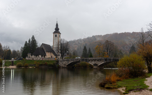 Obraz na płótnie Tranquil scene of st. John the baptist's church by bohinj lake in slovenia Cloudy autumn day w salonie